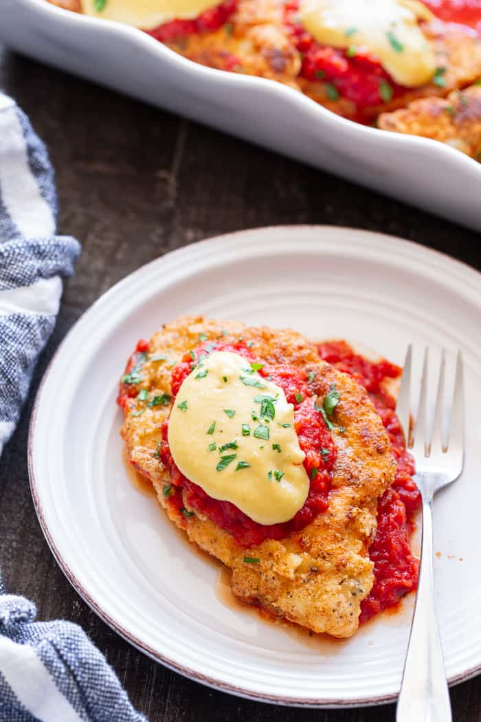 This dairy-free and Paleo Chicken Parmesan has all the flavors of the real deal!  Crisp “breaded” chicken cutlets are layered with marinara and a flavor-packed cashew “cheese” sauce that’s perfect for any special dinner.   Gluten-free, no sugar added, dairy-free.