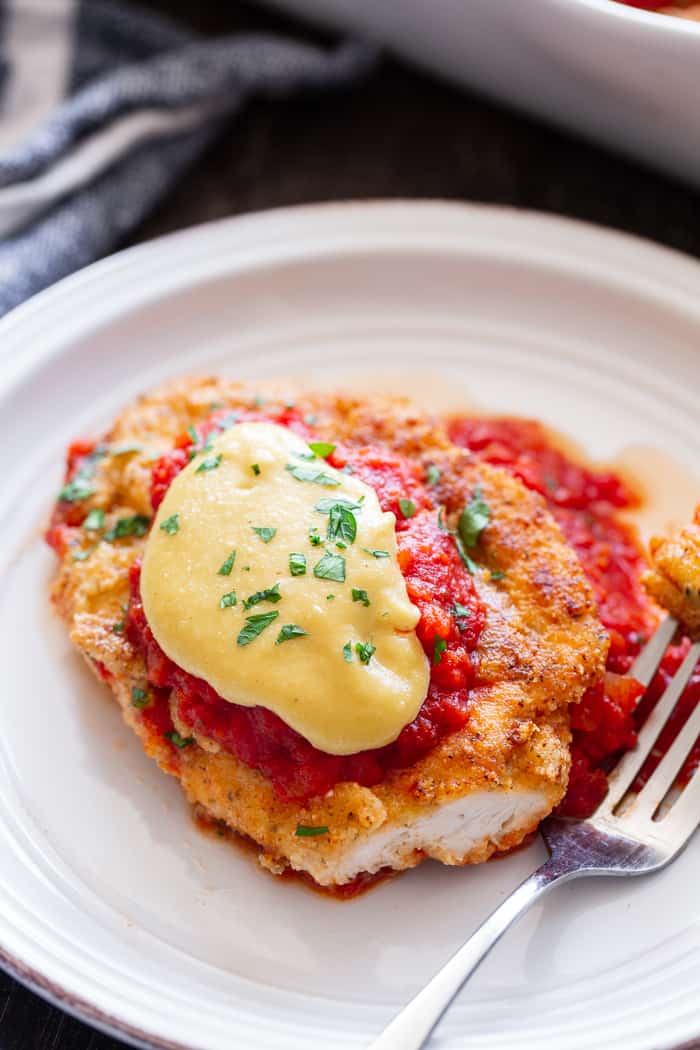 This dairy-free and Paleo Chicken Parmesan has all the flavors of the real deal!  Crisp “breaded” chicken cutlets are layered with marinara and a flavor-packed cashew “cheese” sauce that’s perfect for any special dinner.   Gluten-free, no sugar added, dairy-free.