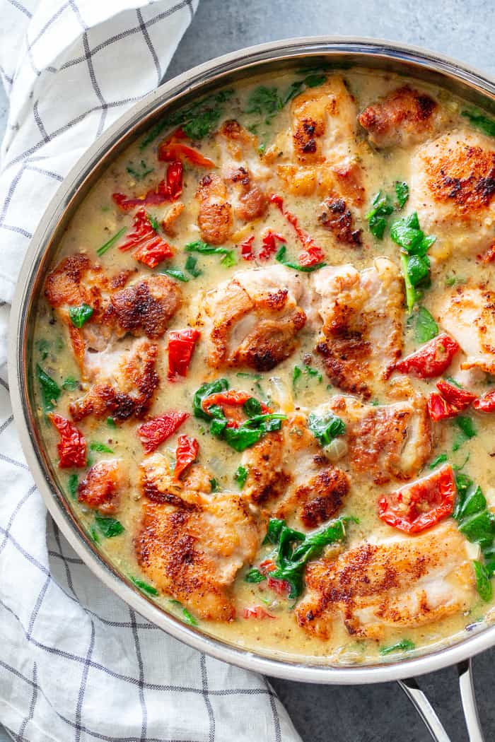 This creamy paleo tuscan chicken is a super-tasty one-skillet meal that’s perfect for weeknights and full of flavor!  Boneless, skinless chicken thighs are seared and cooked with a creamy sauce packed with spinach and sun-dried tomatoes. Paleo, dairy-free, Whole30, and Keto friendly!