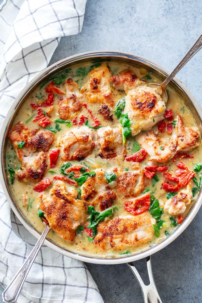 This creamy paleo tuscan chicken is a super-tasty one-skillet meal that’s perfect for weeknights and full of flavor!  Boneless, skinless chicken thighs are seared and cooked with a creamy sauce packed with spinach and sun-dried tomatoes. Paleo, dairy-free, Whole30, and Keto friendly!