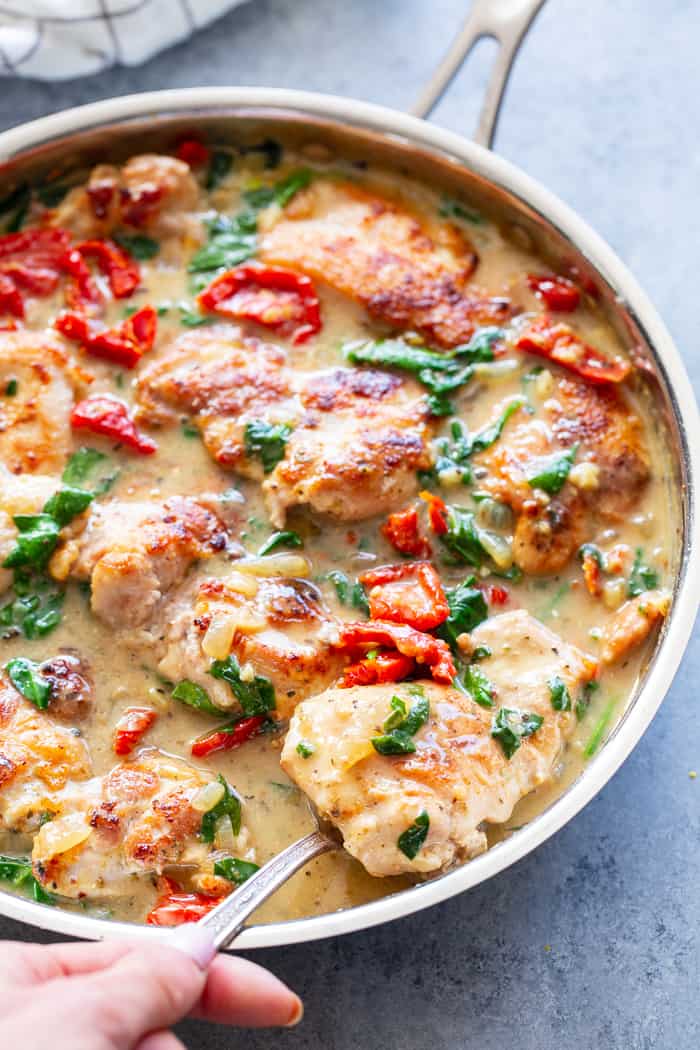 This creamy paleo tuscan chicken is a super-tasty one-skillet meal that’s perfect for weeknights and full of flavor!  Boneless, skinless chicken thighs are seared and cooked with a creamy sauce packed with spinach and sun-dried tomatoes. Paleo, dairy-free, Whole30, and Keto friendly!