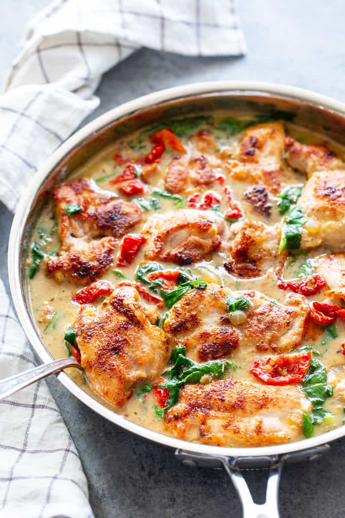 This creamy paleo tuscan chicken is a super-tasty one-skillet meal that’s perfect for weeknights and full of flavor!  Boneless, skinless chicken thighs are seared and cooked with a creamy sauce packed with spinach and sun-dried tomatoes. Paleo, dairy-free, Whole30, and Keto friendly!