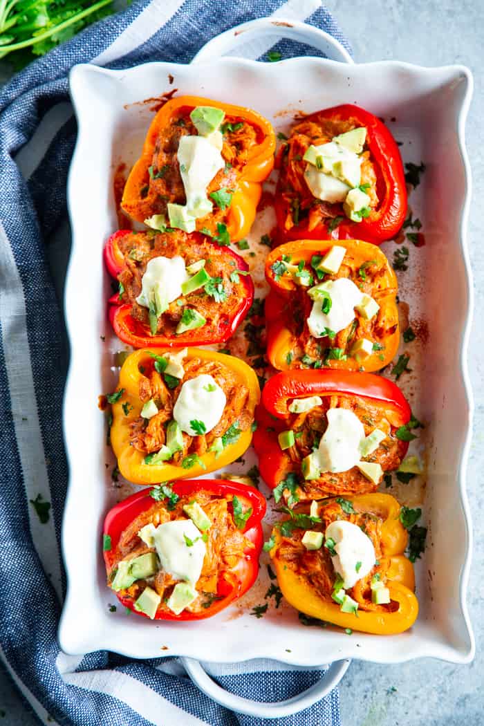 These chicken enchilada stuffed peppers have a creamy, savory, flavor-packed filling that you won’t believe is dairy-free, paleo, and Whole30 compliant!  These stuffed peppers are easy to throw together and perfect to make ahead of time for weeknights.