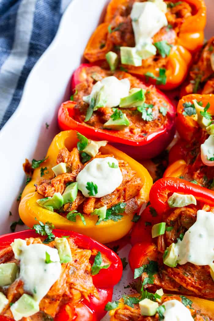 These chicken enchilada stuffed peppers have a creamy, savory, flavor-packed filling that you won’t believe is dairy-free, paleo, and Whole30 compliant!  These stuffed peppers are easy to throw together and perfect to make ahead of time for weeknights.