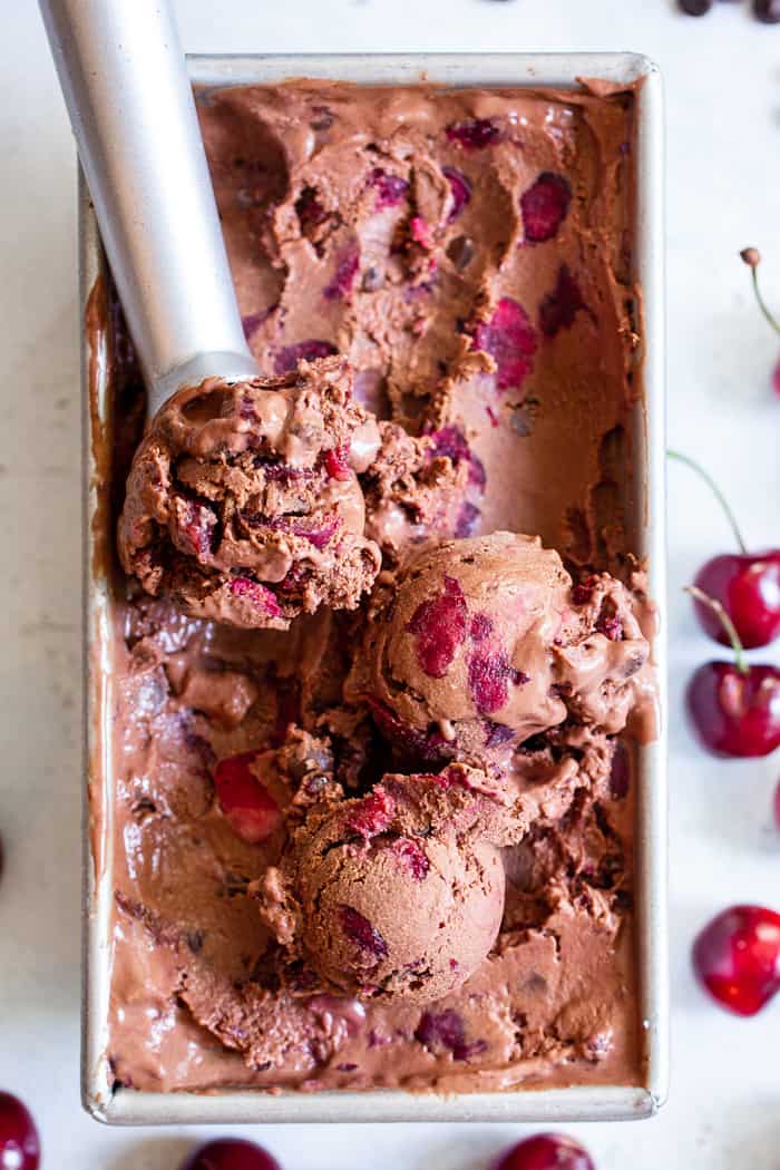 This Double Chocolate Chip Cherry Ice Cream is easy to make at home and you don’t even need an ice cream maker!  It has a rich and creamy texture and loads of chocolate and sweet fresh cherries mixed in.  Refined sugar free, vegan, paleo and kid approved!