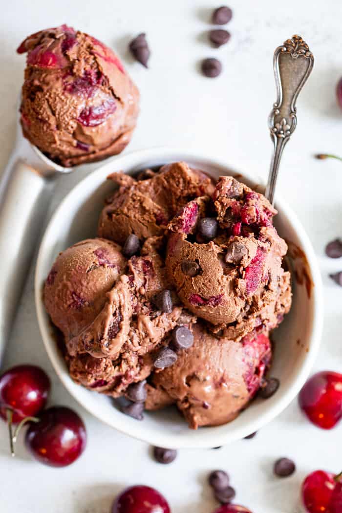 This Double Chocolate Chip Cherry Ice Cream is easy to make at home and you don’t even need an ice cream maker!  It has a rich and creamy texture and loads of chocolate and sweet fresh cherries mixed in.  Refined sugar free, vegan, paleo and kid approved!