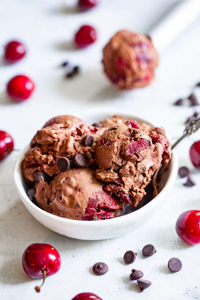 This Double Chocolate Chip Cherry Ice Cream is easy to make at home and you don’t even need an ice cream maker!  It has a rich and creamy texture and loads of chocolate and sweet fresh cherries mixed in.  Refined sugar free, vegan, paleo and kid approved!