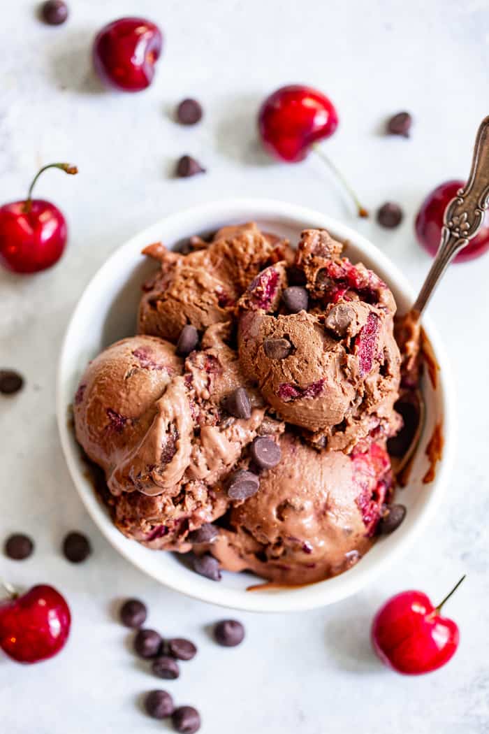 This Double Chocolate Chip Cherry Ice Cream is easy to make at home and you don’t even need an ice cream maker!  It has a rich and creamy texture and loads of chocolate and sweet fresh cherries mixed in.  Refined sugar free, vegan, paleo and kid approved!