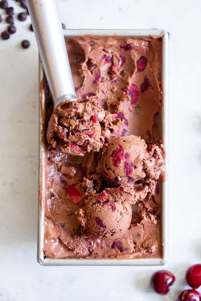 This Double Chocolate Chip Cherry Ice Cream is easy to make at home and you don’t even need an ice cream maker!  It has a rich and creamy texture and loads of chocolate and sweet fresh cherries mixed in.  Refined sugar free, vegan, paleo and kid approved!