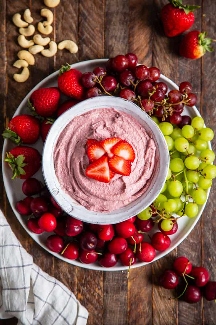 This creamy strawberry cheesecake dip is perfect for dipping fruit or as a spread on quick breads and muffins.  A strawberry puree  is swirled into a cashew based “cheesecake” dip making a fruity, sweet, tangy dip that’s great to serve to a crowd.