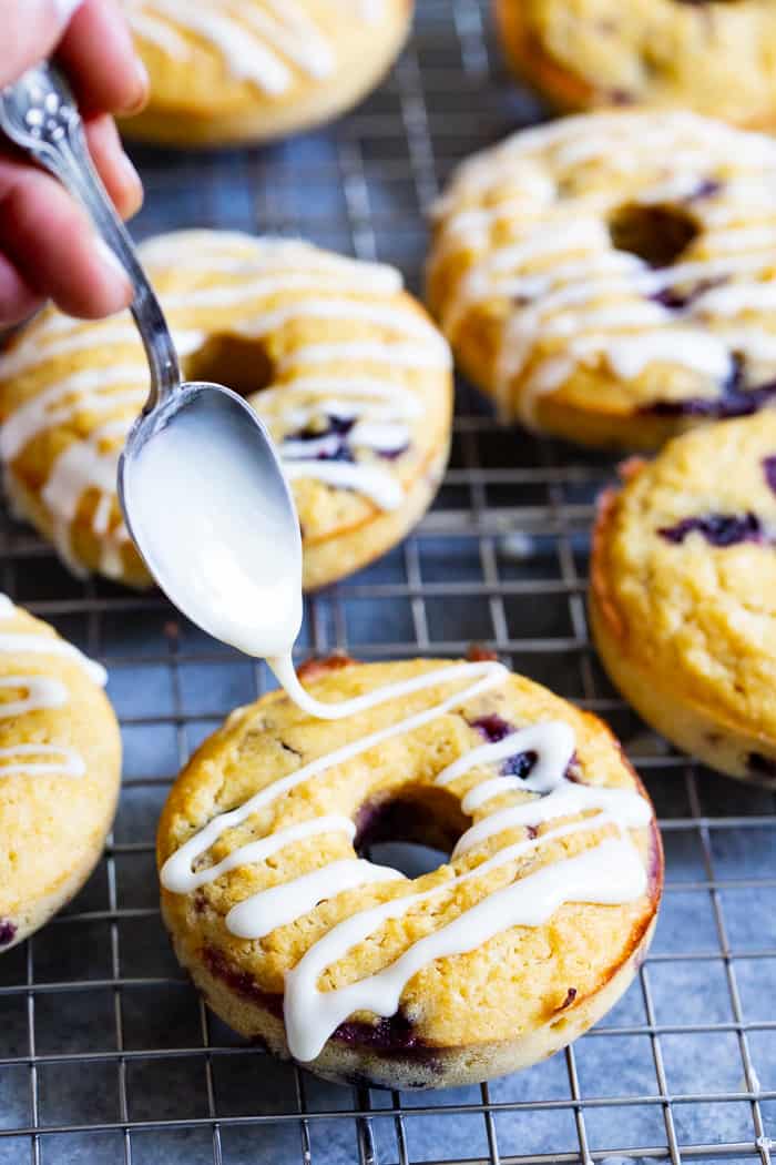 These Paleo and nut free lemon blueberry donuts are sweet moist and cake-like plus packed with juicy blueberry flavor.  They’re drizzled with a lemony sweet glaze making them great as a special breakfast treat, snack, or dessert.