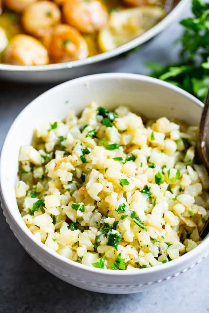 Pan seared scallops are taken to the next level with a lemon garlic “butter” sauce that’s made with ghee instead of butter.  Served with a simple herbed cauliflower rice, this quick and easy dinner is full of flavor, low carb, keto Paleo, and Whole30 compliant.