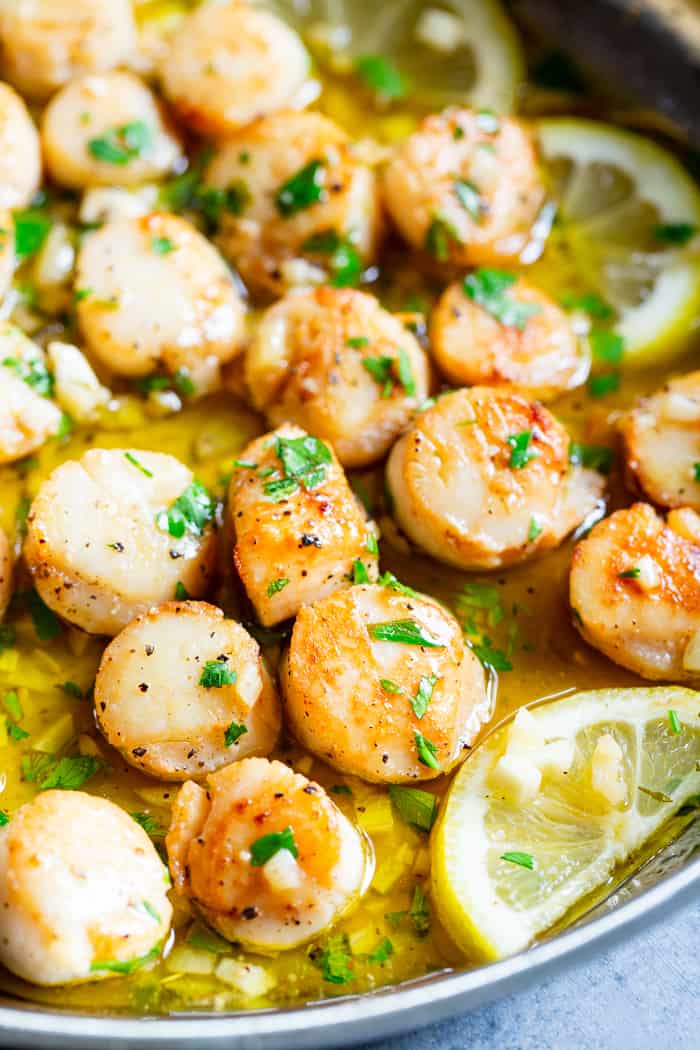 Pan seared scallops are taken to the next level with a lemon garlic “butter” sauce that’s made with ghee instead of butter.  Served with a simple herbed cauliflower rice, this quick and easy dinner is full of flavor, low carb, keto Paleo, and Whole30 compliant.