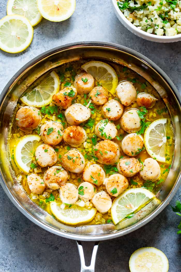 Pan seared scallops are taken to the next level with a lemon garlic “butter” sauce that’s made with ghee instead of butter.  Served with a simple herbed cauliflower rice, this quick and easy dinner is full of flavor, low carb, keto Paleo, and Whole30 compliant.