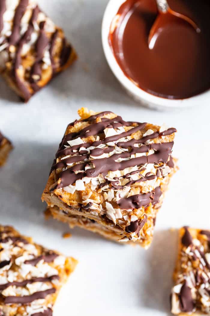 These dreamy cookie bars are a healthier spin on my favorite Girl Scout cookies from childhood. An easy shortbread crust topped with a caramel coconut layer, and drizzled all over with melted dark chocolate. These chewy sweet bars are gluten free, dairy free, paleo, and vegan.