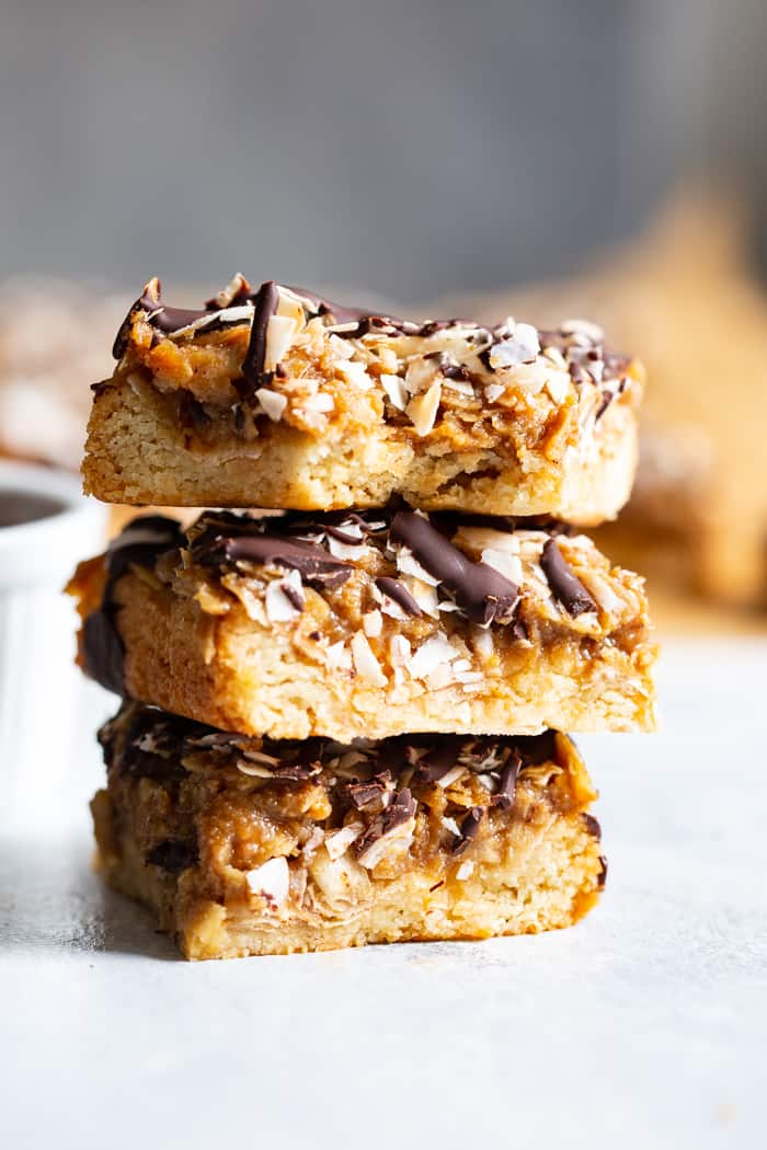 These dreamy cookie bars are a healthier spin on my favorite Girl Scout cookies from childhood. An easy shortbread crust topped with a caramel coconut layer, and drizzled all over with melted dark chocolate. These chewy sweet bars are gluten free, dairy free, paleo, and vegan.