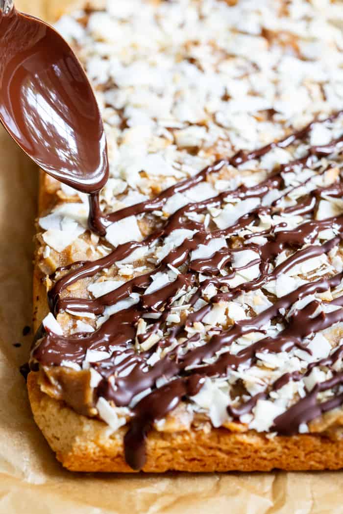 These dreamy cookie bars are a healthier spin on my favorite Girl Scout cookies from childhood. An easy shortbread crust topped with a caramel coconut layer, and drizzled all over with melted dark chocolate. These chewy sweet bars are gluten free, dairy free, paleo, and vegan.