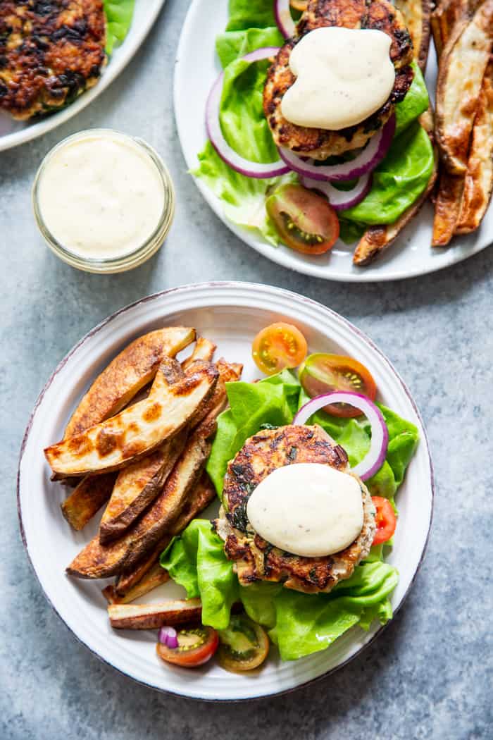 These chicken burgers are packed with veggies and tons of flavor!  A savory spinach artichoke mixture is added to the burgers before they’re grilled and topped with more goodies!  Whole30, paleo, and keto friendly.  A healthy way to break out of your burger rut!