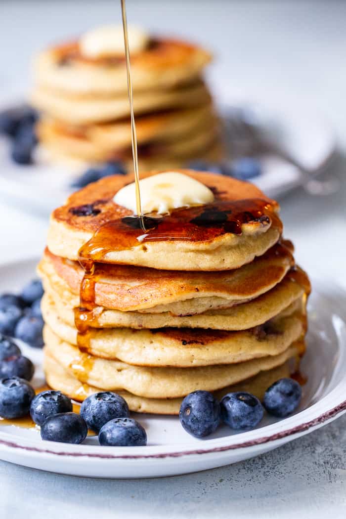 These fluffy paleo buttermilk blueberry pancakes are the perfect healthy answer to your pancake cravings! They come together quickly and are a hit with kids and adults alike. Grain free, nut free, dairy free and freezable, which makes them great for breakfast or brunch anytime!