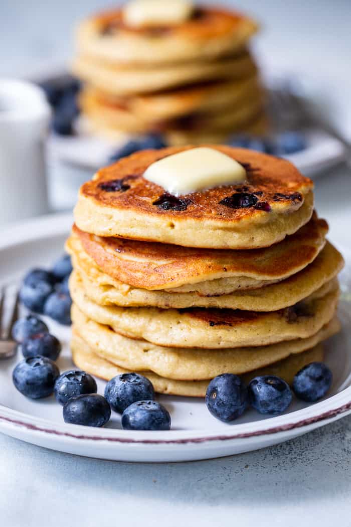 These fluffy paleo buttermilk blueberry pancakes are the perfect healthy answer to your pancake cravings! They come together quickly and are a hit with kids and adults alike. Grain free, nut free, dairy free and freezable, which makes them great for breakfast or brunch anytime!