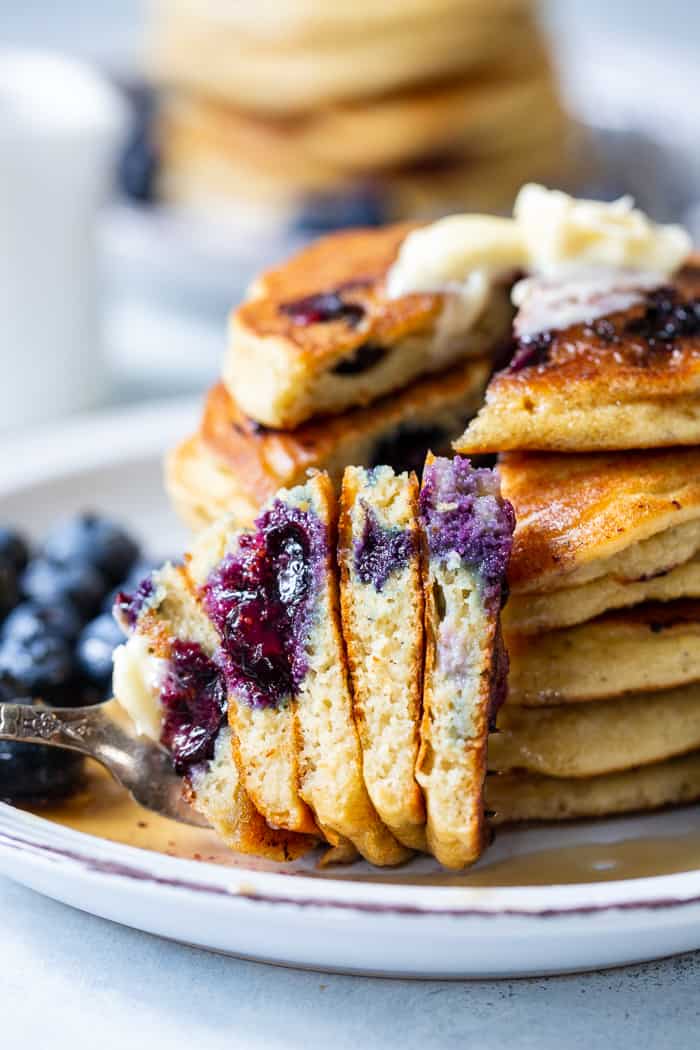 These fluffy paleo buttermilk blueberry pancakes are the perfect healthy answer to your pancake cravings! They come together quickly and are a hit with kids and adults alike. Grain free, nut free, dairy free and freezable, which makes them great for breakfast or brunch anytime!