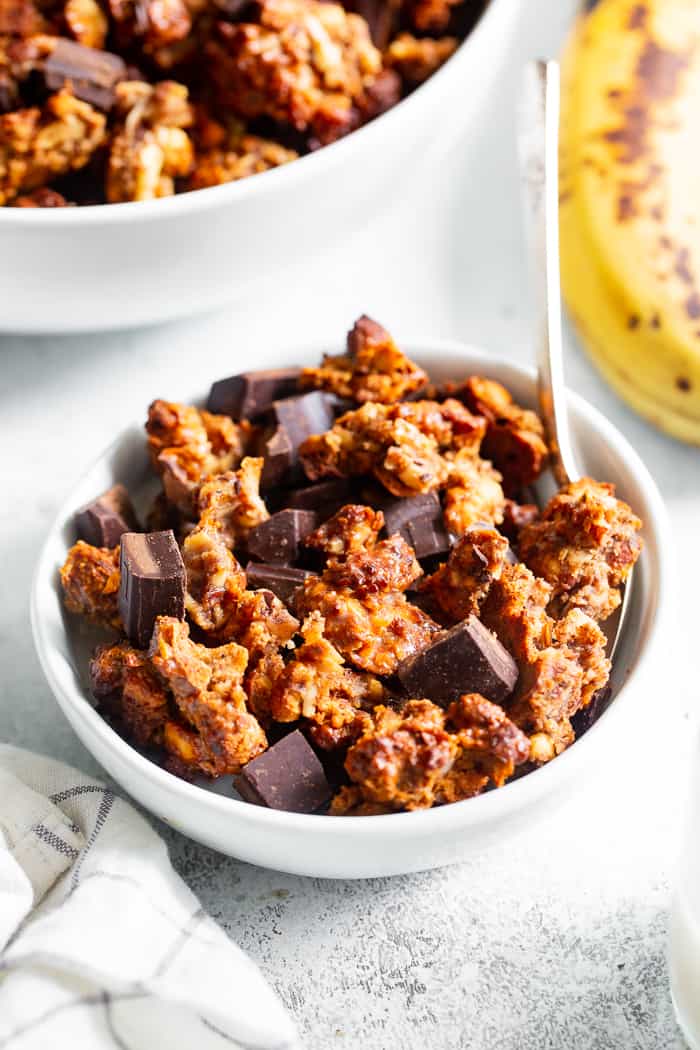Like all things “chunky monkey” this paleo and vegan chunky monkey granola is about to become a favorite!  It’s sweet, nutty, with lots of big clusters and chocolate chunks.  Sweetened with bananas and pure maple syrup and totally grain free and dairy free.