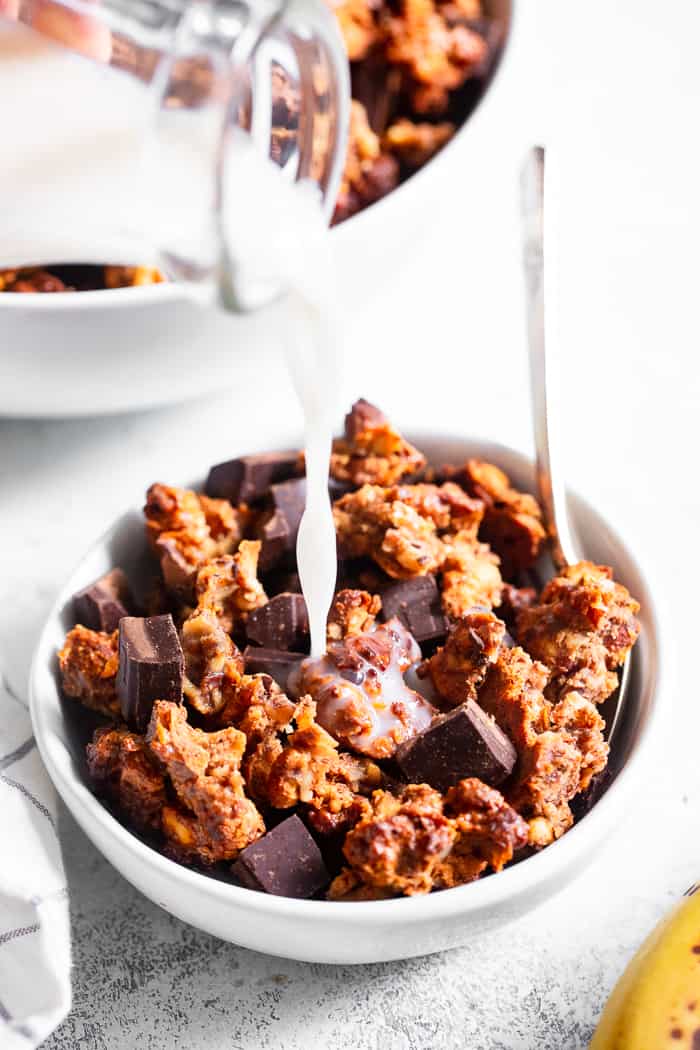 Like all things “chunky monkey” this paleo and vegan chunky monkey granola is about to become a favorite!  It’s sweet, nutty, with lots of big clusters and chocolate chunks.  Sweetened with bananas and pure maple syrup and totally grain free and dairy free.