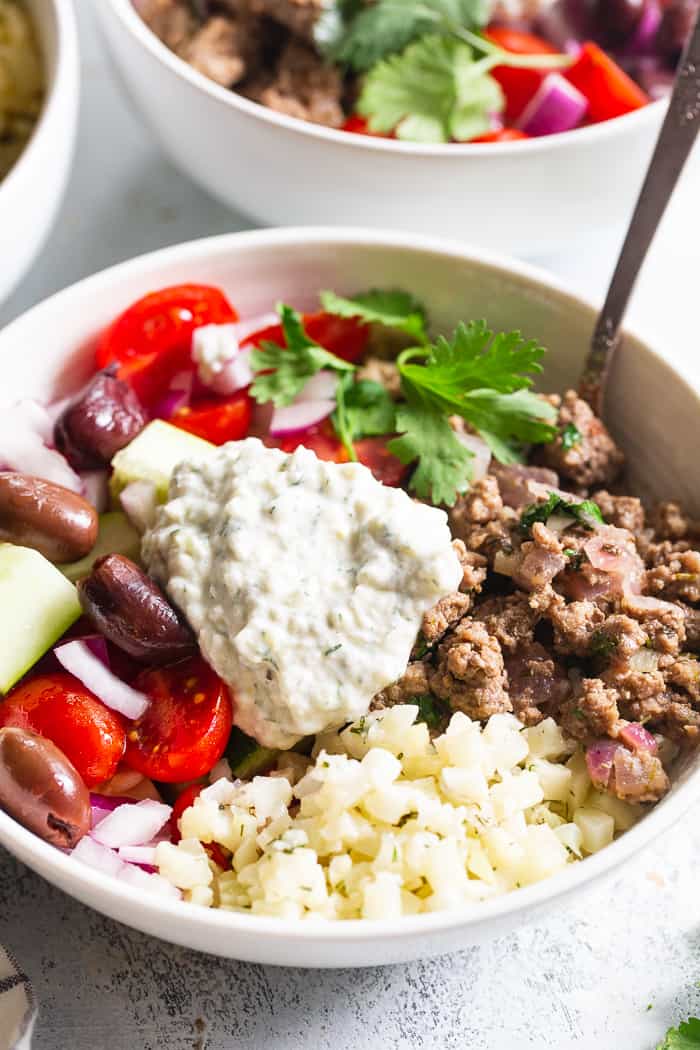 These super tasty low carb, Paleo, and Whole30 gyro bowls are perfect for a weeknight meal and are easy to meal prep too. You won’t miss the dairy or grains at all with these flavor and veggie packed healthy gyro bowls! 