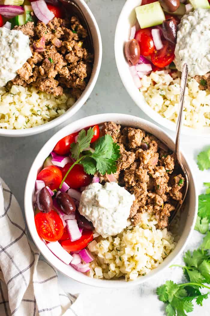 These super tasty low carb, Paleo, and Whole30 gyro bowls are perfect for a weeknight meal and are easy to meal prep too. You won’t miss the dairy or grains at all with these flavor and veggie packed healthy gyro bowls! 