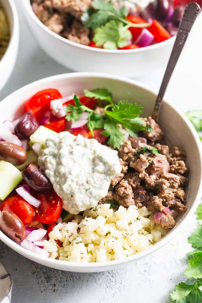 These super tasty low carb, Paleo, and Whole30 gyro bowls are perfect for a weeknight meal and are easy to meal prep too. You won’t miss the dairy or grains at all with these flavor and veggie packed healthy gyro bowls! 