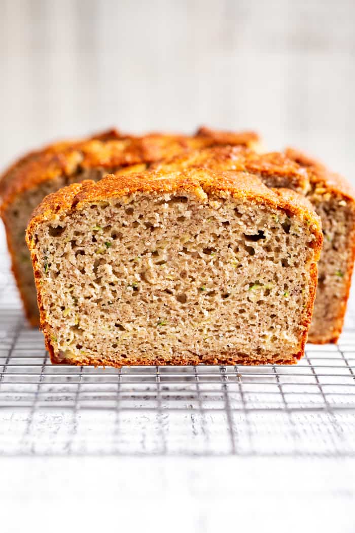 This gluten free and paleo zucchini banana bread is soft and tender, moist, cake-like and has just the right amount of sweetness.  Perfect for breakfast toasted and slathered with almond butter or for an afternoon snack.  Experiment with adding your favorite mix-ins to this simple grain free, dairy free quick bread!