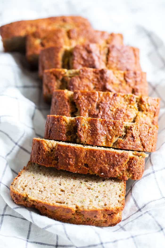 This gluten free and paleo zucchini banana bread is soft and tender, moist, cake-like and has just the right amount of sweetness.  Perfect for breakfast toasted and slathered with almond butter or for an afternoon snack.  Experiment with adding your favorite mix-ins to this simple grain free, dairy free quick bread!