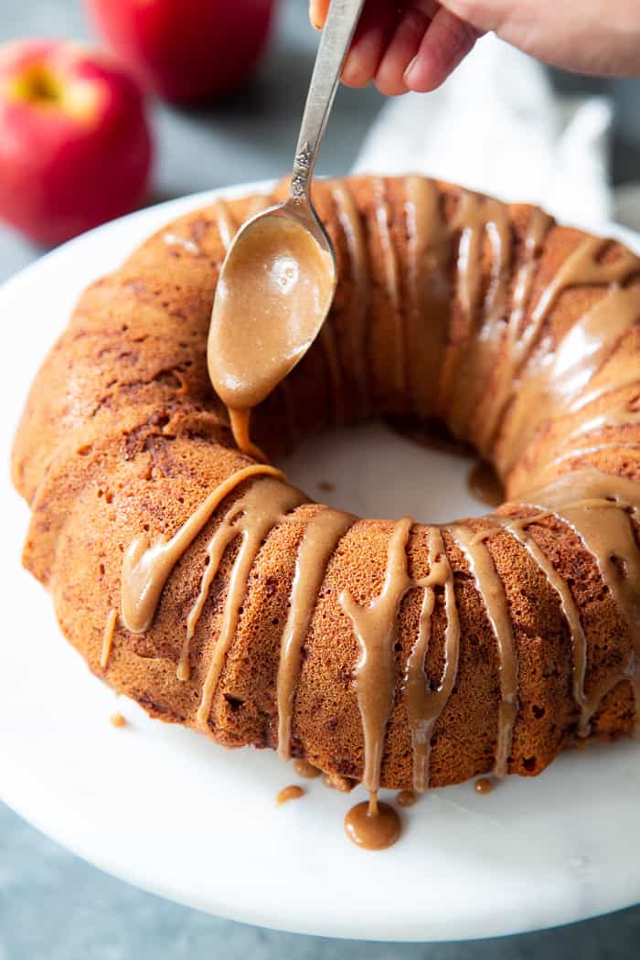 This Glazed Apple Bundt Cake is a healthier spin on a fall baking favorite!  It’s moist and fluffy, packed with warm spices and juicy apples, and topped with a refined sugar free maple glaze that’s irresistible.  It’s gluten-free, grain-free, dairy free, and paleo.