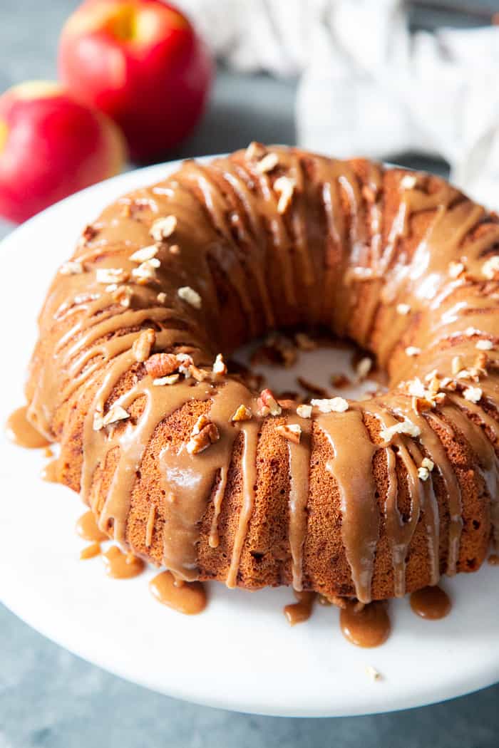 This Glazed Apple Bundt Cake is a healthier spin on a fall baking favorite!  It’s moist and fluffy, packed with warm spices and juicy apples, and topped with a refined sugar free maple glaze that’s irresistible.  It’s gluten-free, grain-free, dairy free, and paleo.