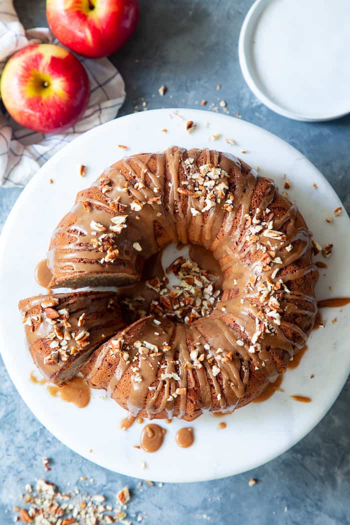 This Glazed Apple Bundt Cake is a healthier spin on a fall baking favorite!  It’s moist and fluffy, packed with warm spices and juicy apples, and topped with a refined sugar free maple glaze that’s irresistible.  It’s gluten-free, grain-free, dairy free, and paleo.