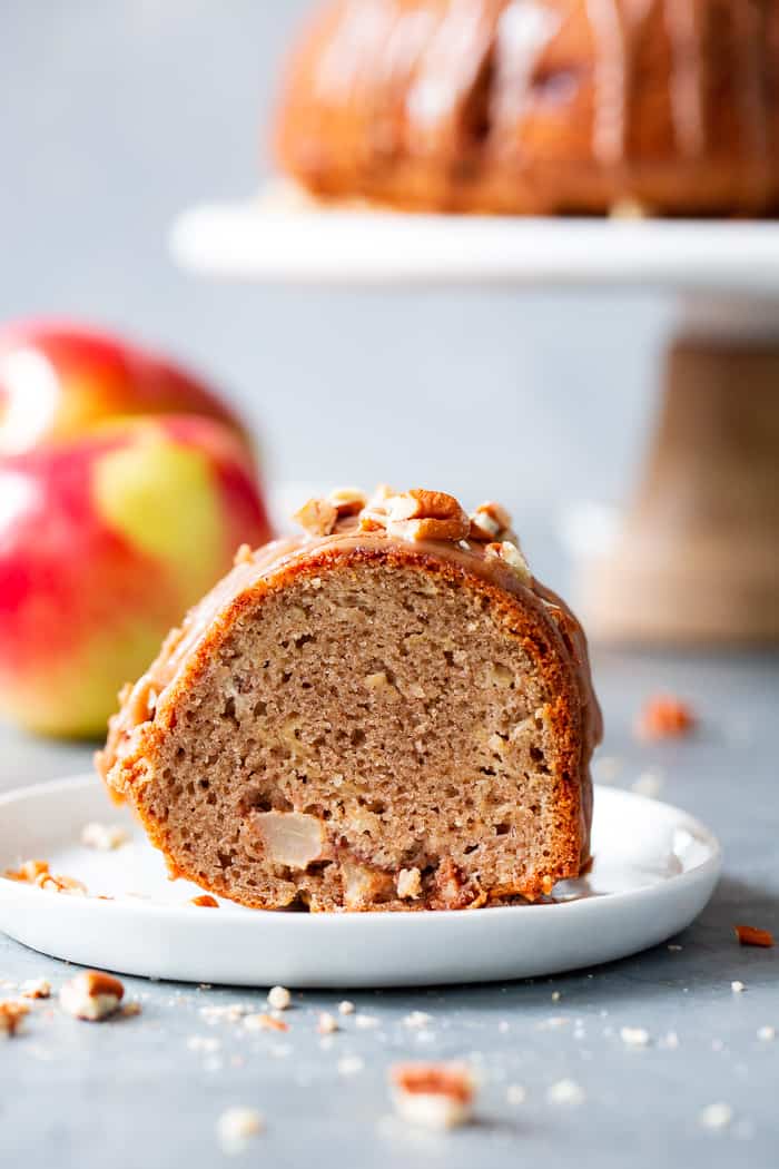 This Glazed Apple Bundt Cake is a healthier spin on a fall baking favorite!  It’s moist and fluffy, packed with warm spices and juicy apples, and topped with a refined sugar free maple glaze that’s irresistible.  It’s gluten-free, grain-free, dairy free, and paleo.