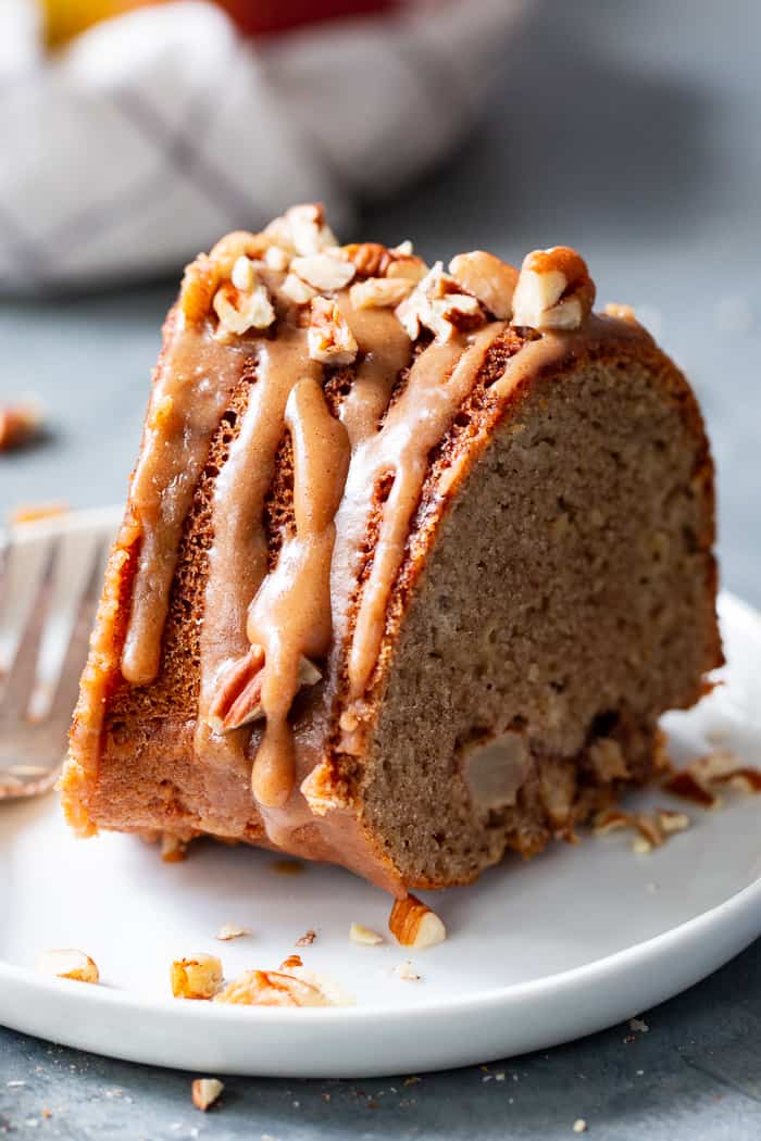 This Glazed Apple Bundt Cake is a healthier spin on a fall baking favorite!  It’s moist and fluffy, packed with warm spices and juicy apples, and topped with a refined sugar free maple glaze that’s irresistible.  It’s gluten-free, grain-free, dairy free, and paleo.