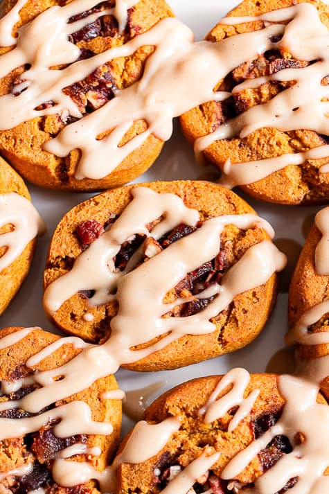 close up of paleo pumpkin cinnamon rolls with maple icing