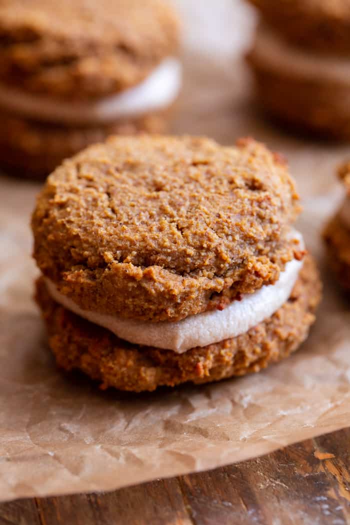 These soft pumpkin cookies are sweet and packed with warm spices and a sweet maple cream filling.  You can make them as sandwich cookies or simply spread them with the icing - it’s pumpkin spice heaven either way!  They're gluten free, dairy-free, refined-sugar free and paleo.
