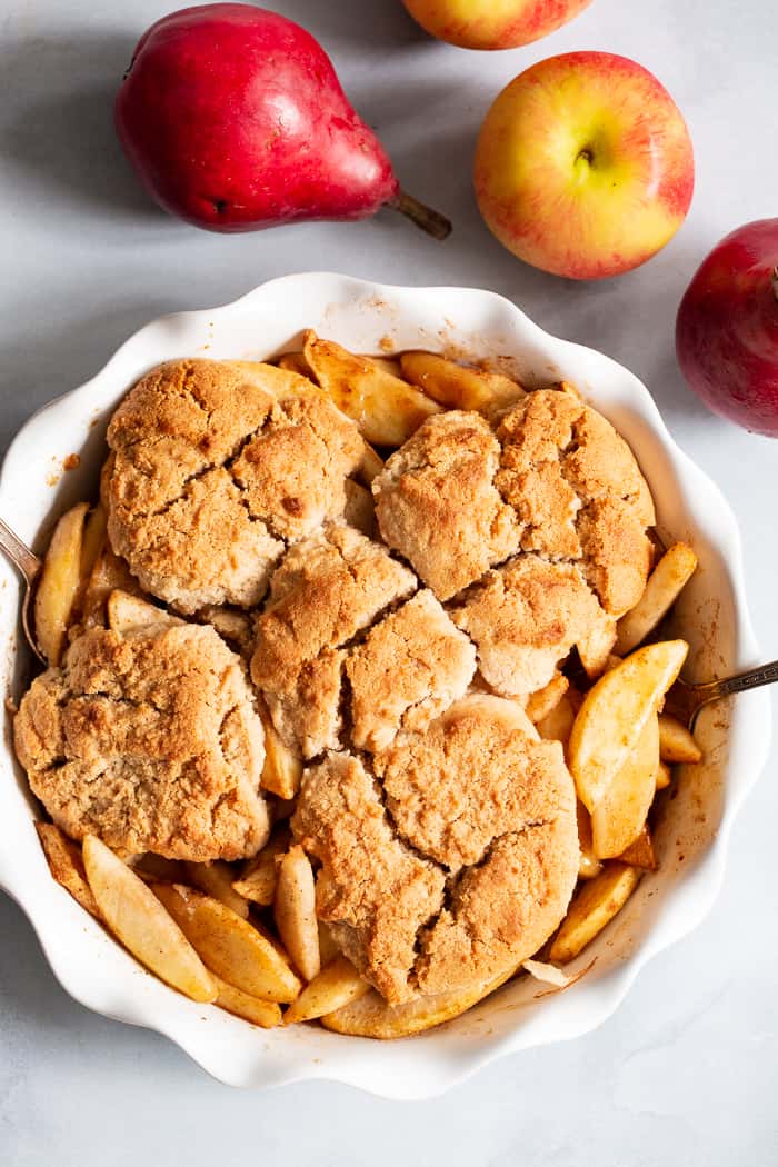 This paleo and vegan pear apple cobbler is a dreamy fall dessert made healthier with no refined sugar, grains, or dairy.  A gooey apple pear filling is topped with sweet crisp cobbler and baked to golden brown perfection!  Serve with your favorite dairy free ice cream for the ultimate treat!