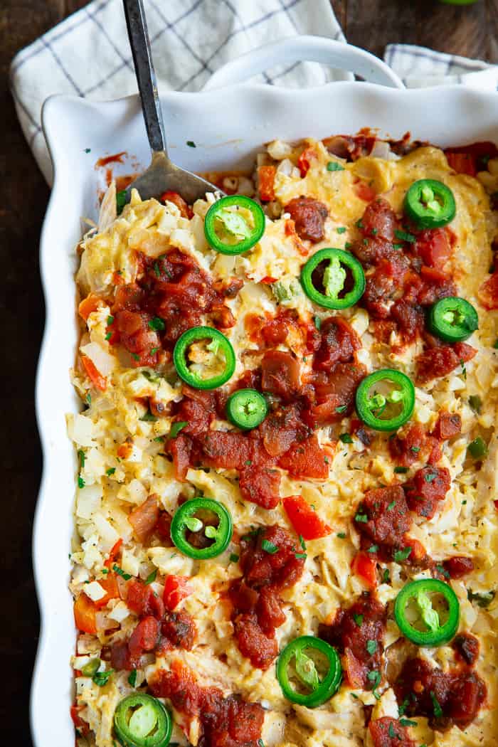 This chicken burrito casserole is packed with savory shredded chicken, a flavorful creamy dairy-free cashew cheese sauce, cauliflower rice, salsa, and peppers and onions.  It’s simple, so satisfying, and so delicious it’s addicting!  Paleo, Whole30 friendly and keto. 