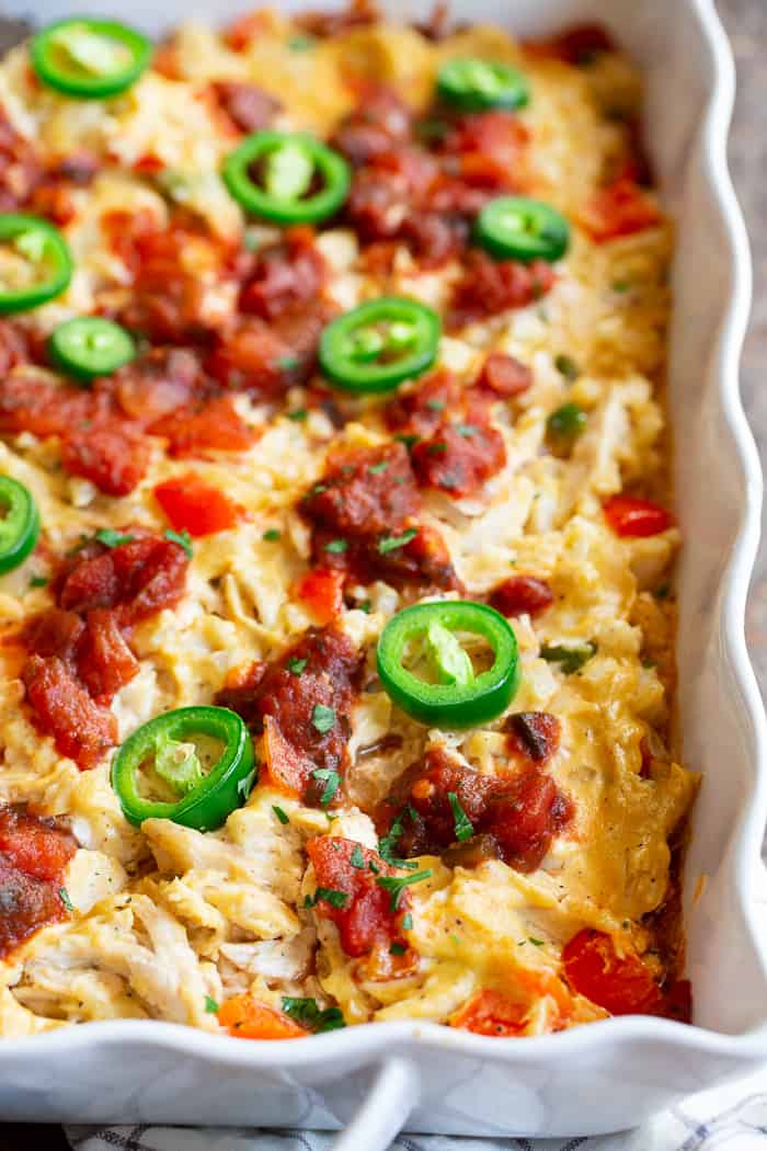 This chicken burrito casserole is packed with savory shredded chicken, a flavorful creamy dairy-free cashew cheese sauce, cauliflower rice, salsa, and peppers and onions.  It’s simple, so satisfying, and so delicious it’s addicting!  Paleo, Whole30 friendly and keto. 