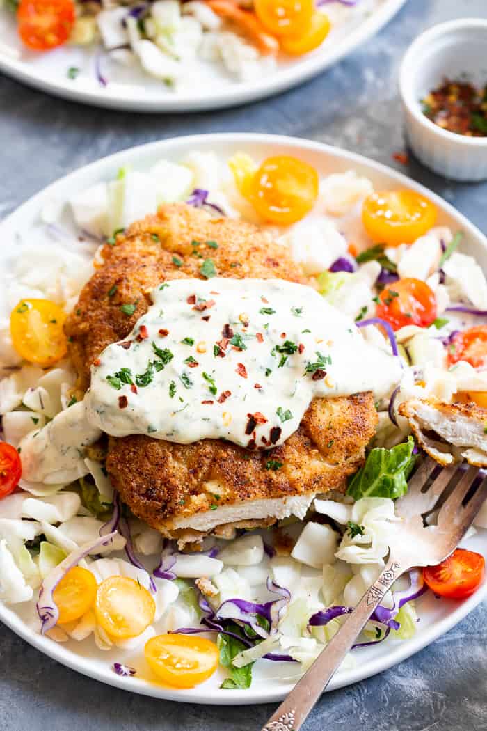 This savory crisp Paleo Chicken Milanese topped with zesty homemade ranch sauce is a quick and easy dinner you’ll want on repeat!  Serve over a salad, spaghetti squash, roasted veggies, or anything you like.  It’s Whole30, Keto friendly, gluten free and dairy free.