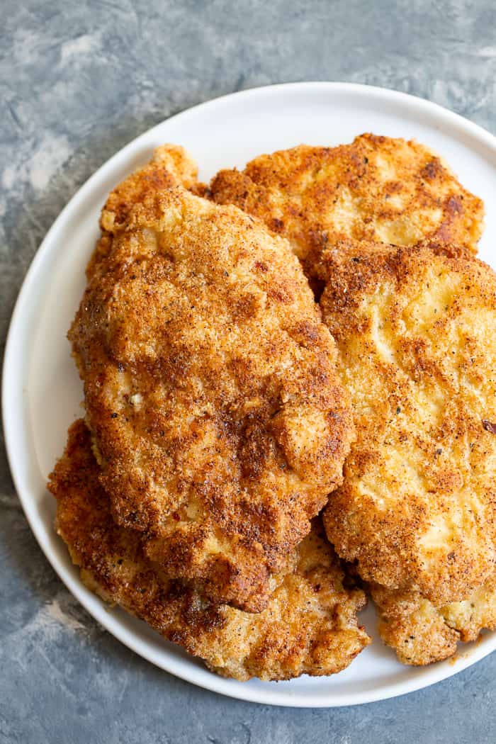 This savory crisp Paleo Chicken Milanese topped with zesty homemade ranch sauce is a quick and easy dinner you’ll want on repeat!  Serve over a salad, spaghetti squash, roasted veggies, or anything you like.  It’s Whole30, Keto friendly, gluten free and dairy free.