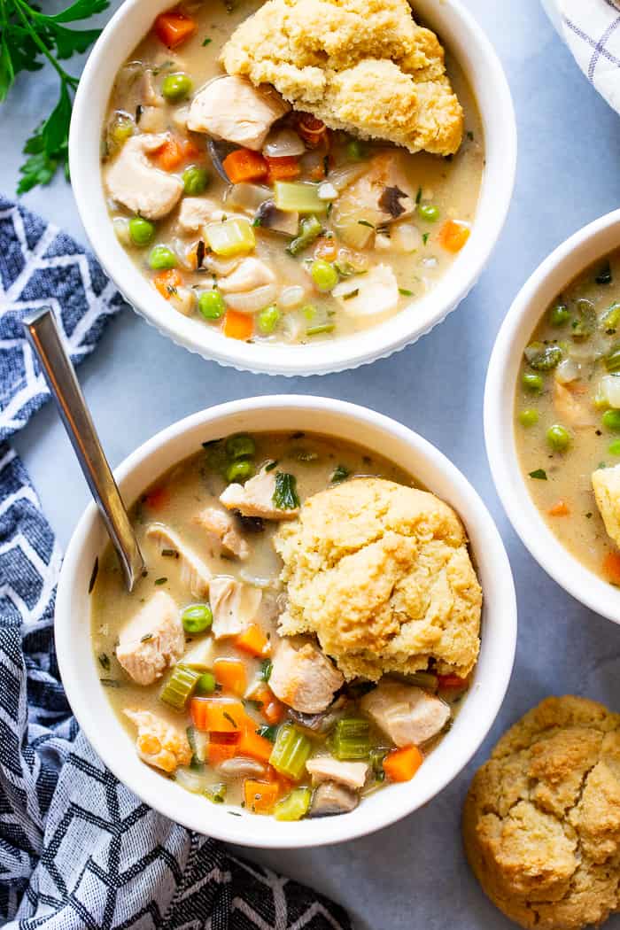 This creamy, cozy and delicious chicken pot pie soup has it all!  A paleo and dairy-free chicken pot pie filling with loads of veggies and savory herbs and the yummiest paleo + low carb biscuits!  The whole family will love this  healthy, hearty soup on cold winter nights.