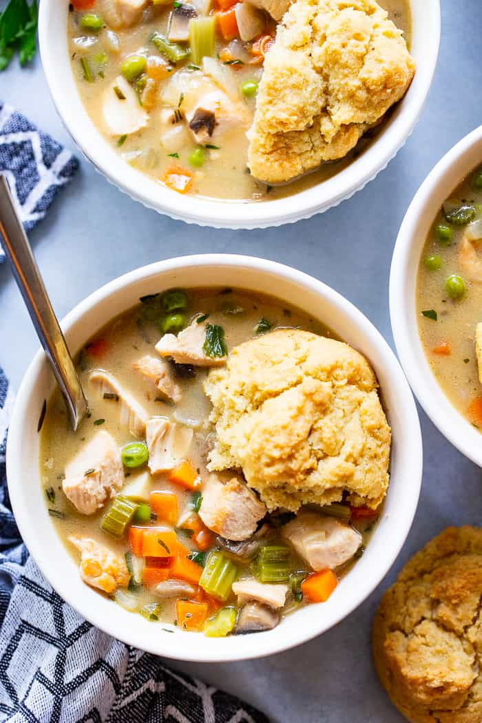 This creamy, cozy and delicious chicken pot pie soup has it all!  A paleo and dairy-free chicken pot pie filling with loads of veggies and savory herbs and the yummiest paleo + low carb biscuits!  The whole family will love this  healthy, hearty soup on cold winter nights.