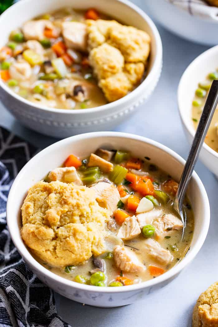 This creamy, cozy and delicious chicken pot pie soup has it all!  A paleo and dairy-free chicken pot pie filling with loads of veggies and savory herbs and the yummiest paleo + low carb biscuits!  The whole family will love this  healthy, hearty soup on cold winter nights.