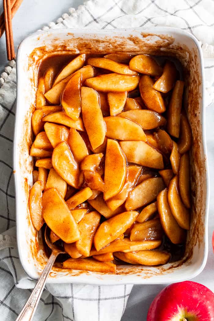 These gooey caramel cinnamon baked apples taste better than apple pie filling with almost no effort at all!  These baked apples are refined sugar free, paleo, vegan, and perfect with a big scoop of coconut vanilla ice cream!