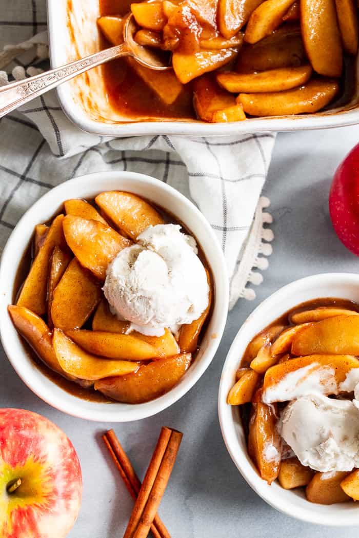 These gooey caramel cinnamon baked apples taste better than apple pie filling with almost no effort at all!  These baked apples are refined sugar free, paleo, vegan, and perfect with a big scoop of coconut vanilla ice cream!