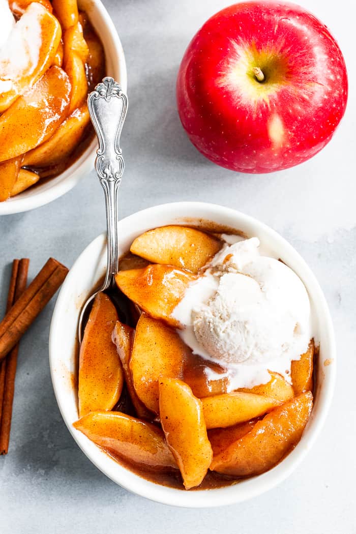 These gooey caramel cinnamon baked apples taste better than apple pie filling with almost no effort at all!  These baked apples are refined sugar free, paleo, vegan, and perfect with a big scoop of coconut vanilla ice cream!